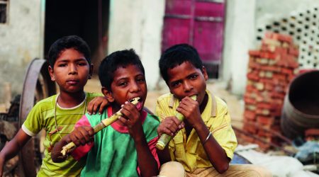 Group Of Children Enjoying Sugarcane
